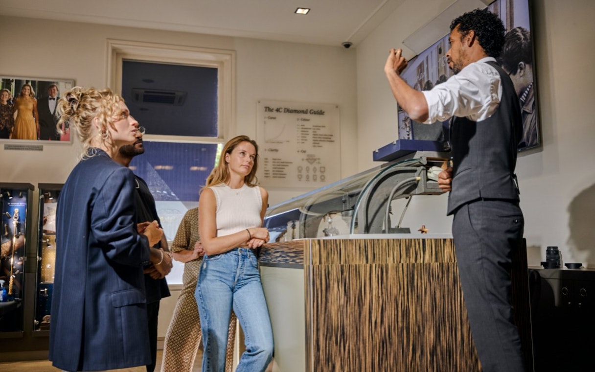 Guests observing diamond polishing demonstration at Royal Coster Diamond Experience, Amsterdam.