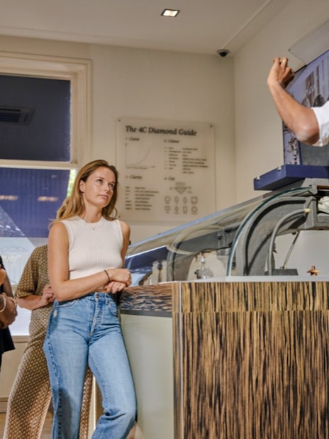 Guests observing diamond polishing demonstration at Royal Coster Diamond Experience, Amsterdam.