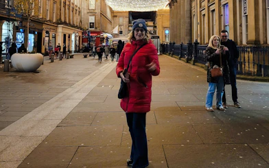 Guest walking on a lit street in Glasgow during the evening.
