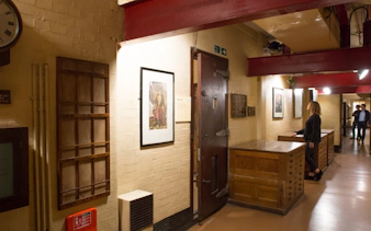Churchill War Rooms corridor with historical displays and visitors exploring exhibits.