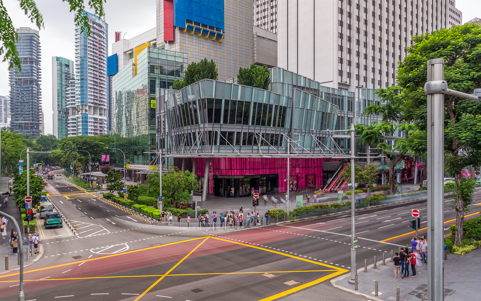 Orchard Road bustling with shoppers and vibrant storefronts in Singapore.