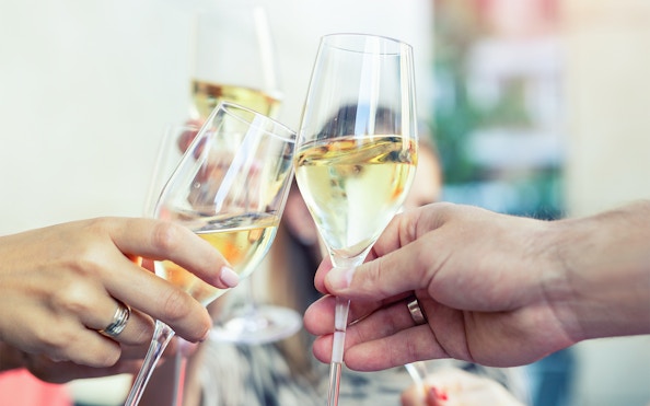 Guests toasting with prosecco on Budapest evening cruise.