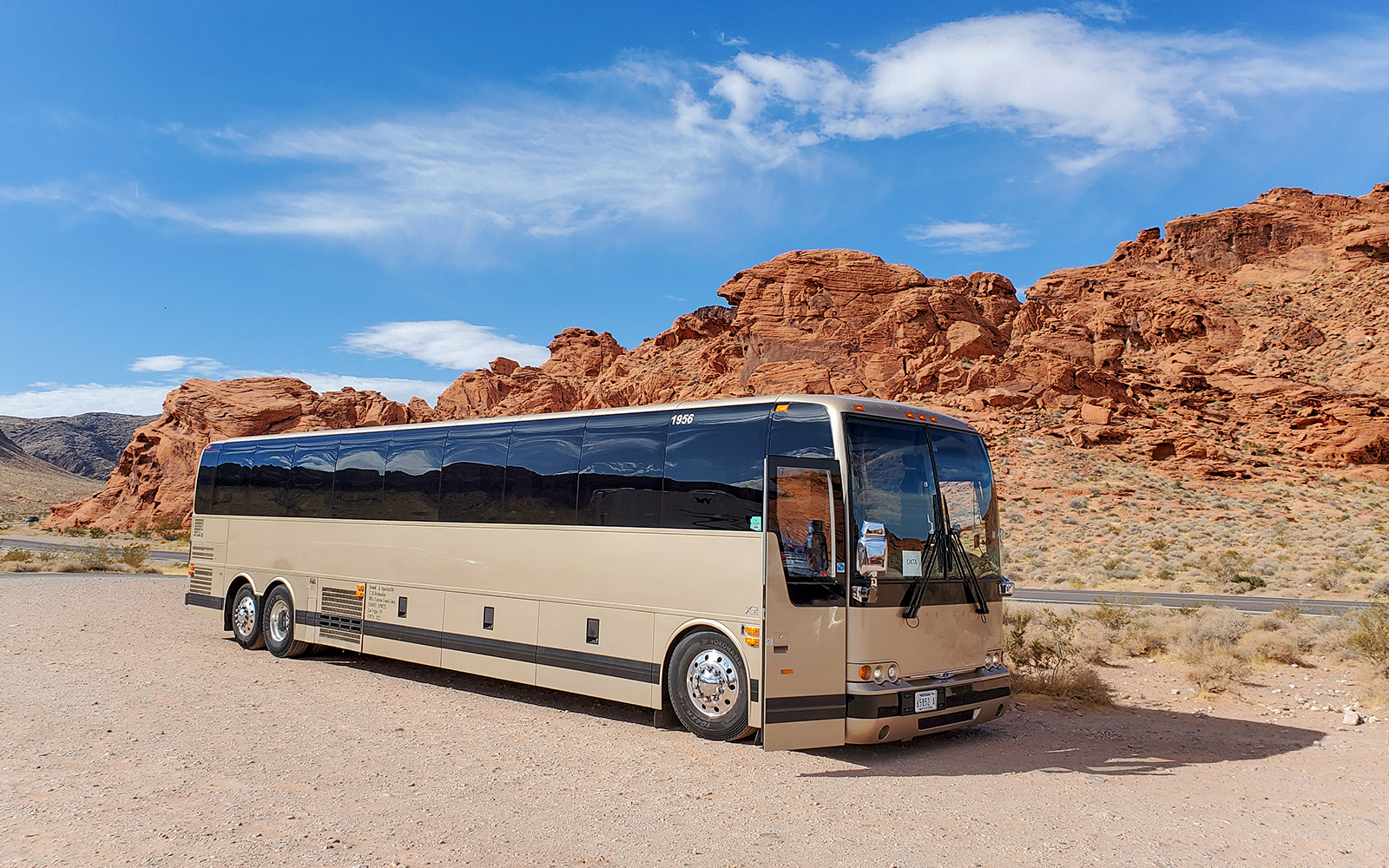 Tour bus parked near red rock formations at Antelope Canyon X, en route from Las Vegas.