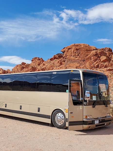 Tour bus parked near red rock formations at Antelope Canyon X, en route from Las Vegas.