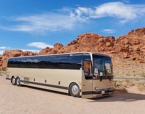 Tour bus parked near red rock formations at Antelope Canyon X, en route from Las Vegas.
