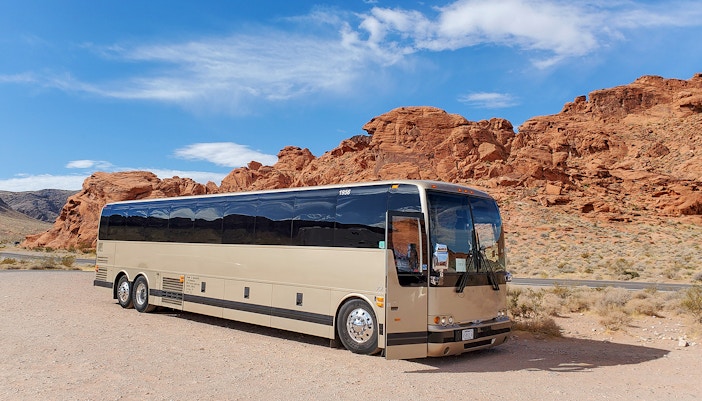 Tour bus parked near red rock formations at Antelope Canyon X, en route from Las Vegas.