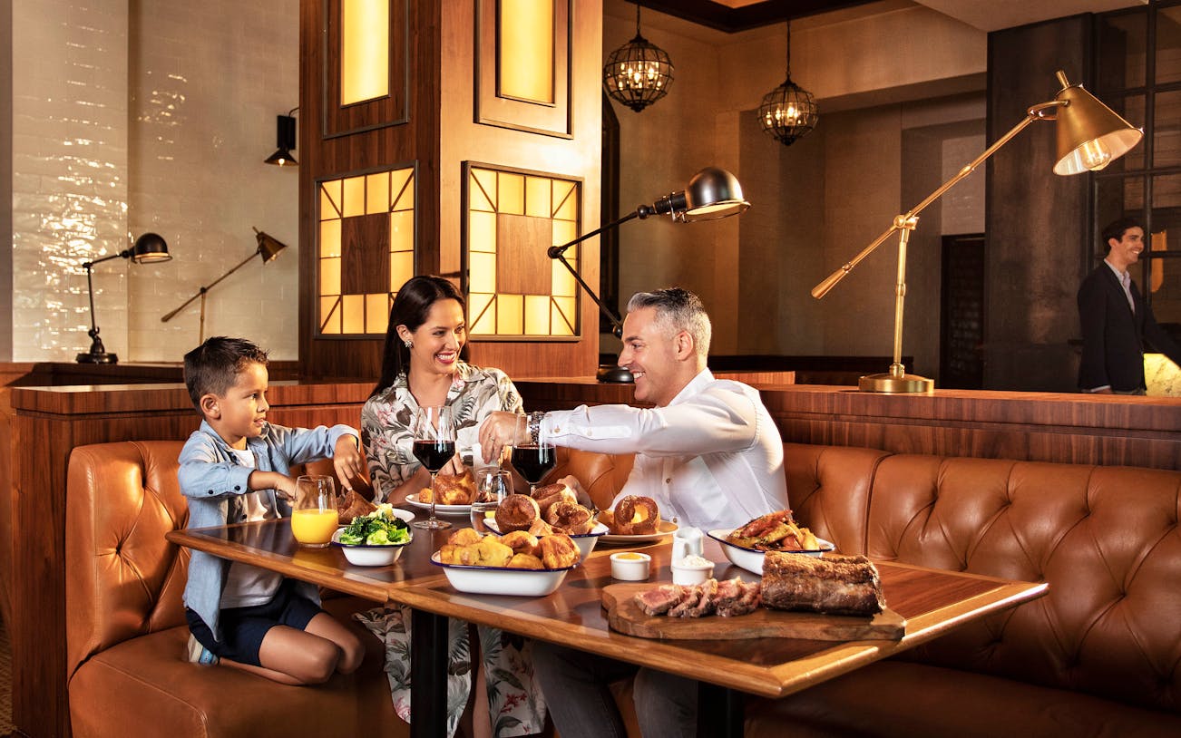 Family dining at Bread Street Kitchen, enjoying set menu in Dubai.