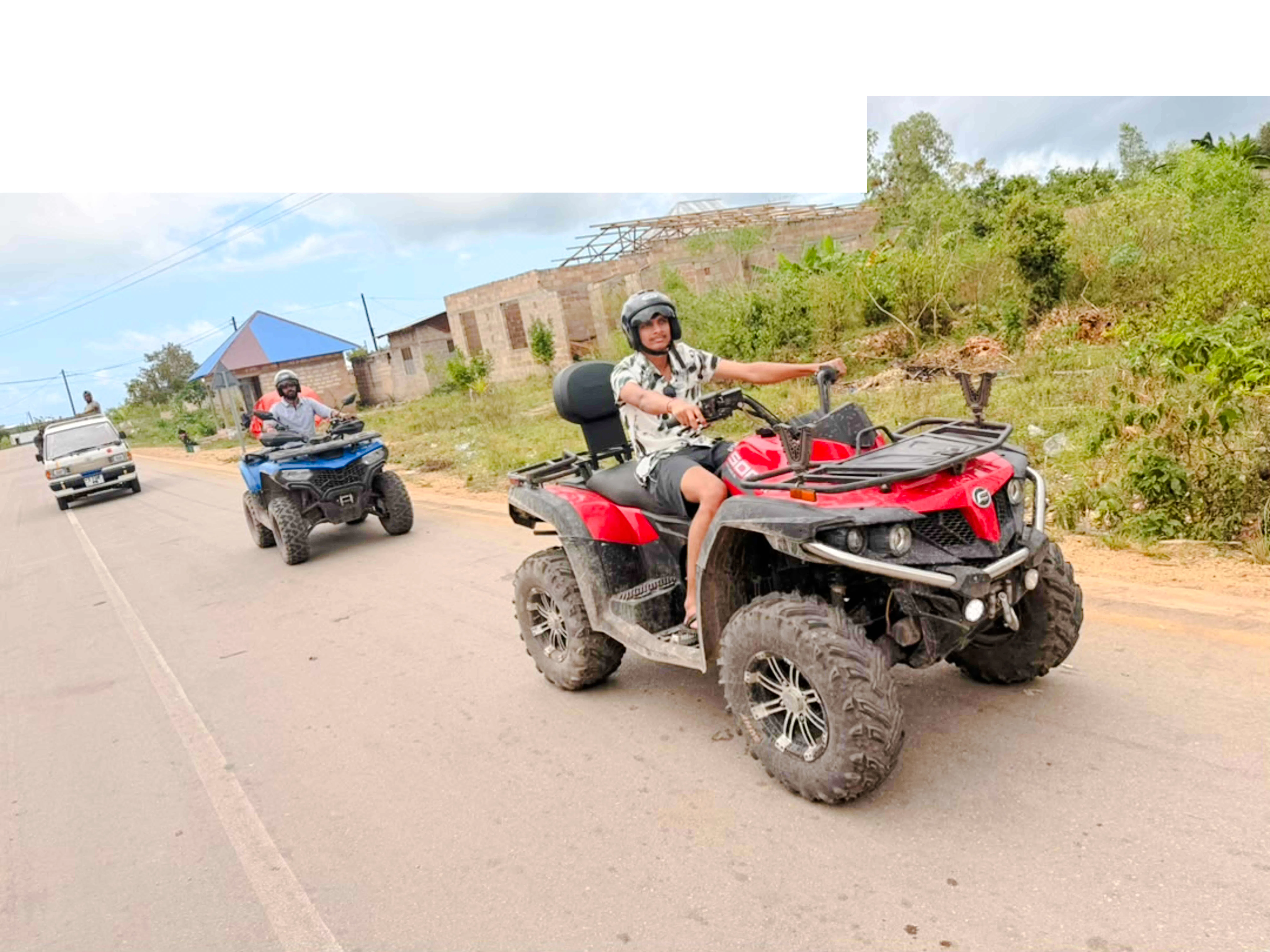 Quad biking on a rural road in Zanzibar, part of the Quad Bike Adventure tour.