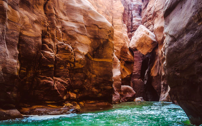 Canyon walls and flowing water at Mujib Reserve, Wadi Mujib, Jordan.