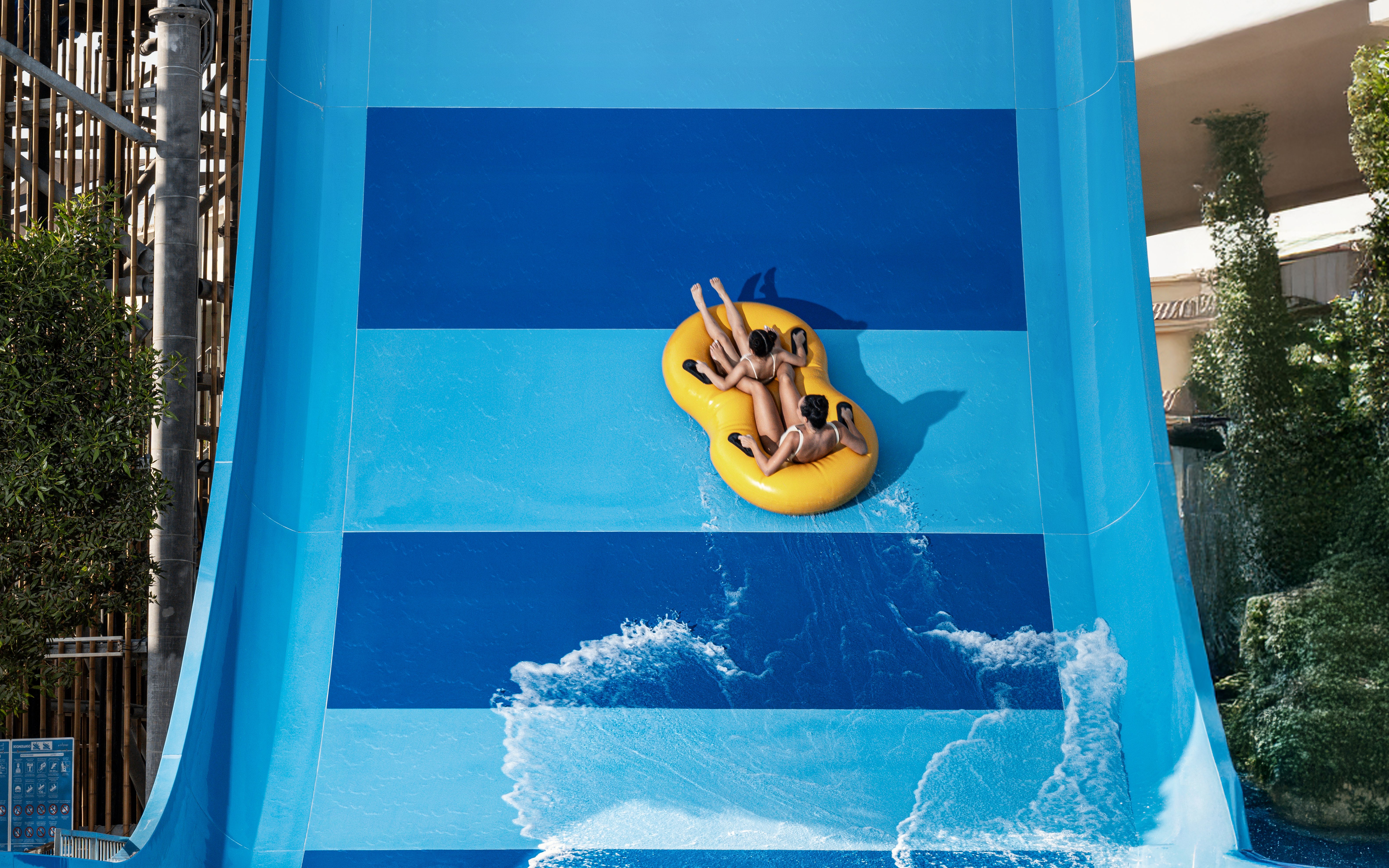 People riding Boomerango slide at Grand Hyatt waterpark, Dubai.