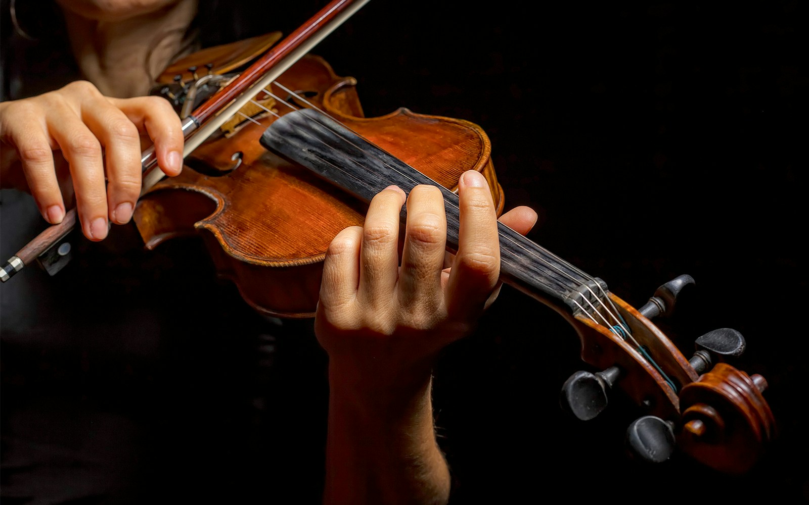 Violinist performing in a vibrant street of Vienna, Austria.