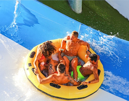 Visitors enjoying water slides at Aquafan Water Park, Riccione, Italy.
