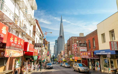 San Francisco Chinatown street with Transamerica Pyramid in the background.
