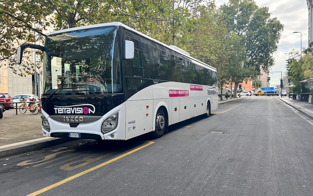 Terravision bus parked on a city street for airport transfer.