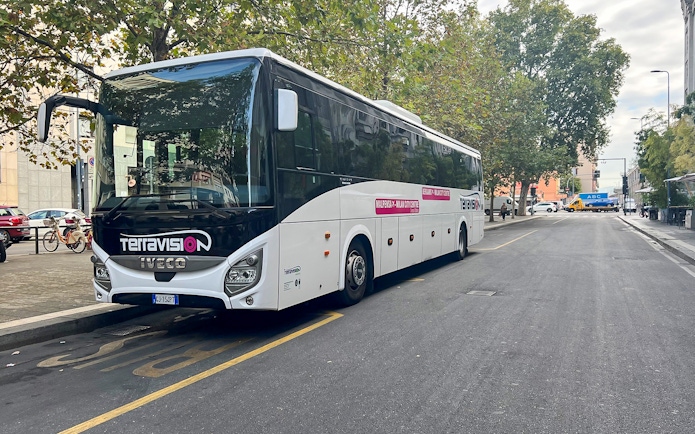 Terravision bus parked on a city street for airport transfer.