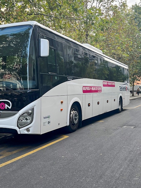 Terravision bus parked on a city street for airport transfer.