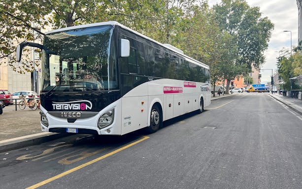 Terravision bus parked on a city street for airport transfer.