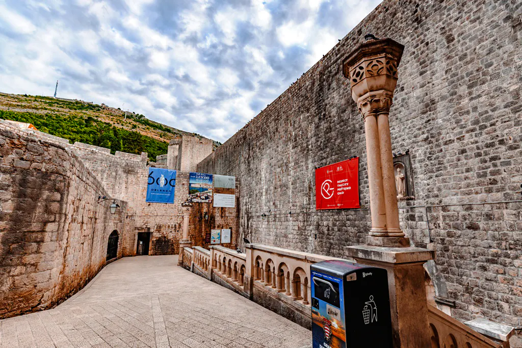 Dubrovnik city walls with banners, part of History Walk & Dubrovnik Panorama by Boat tour.