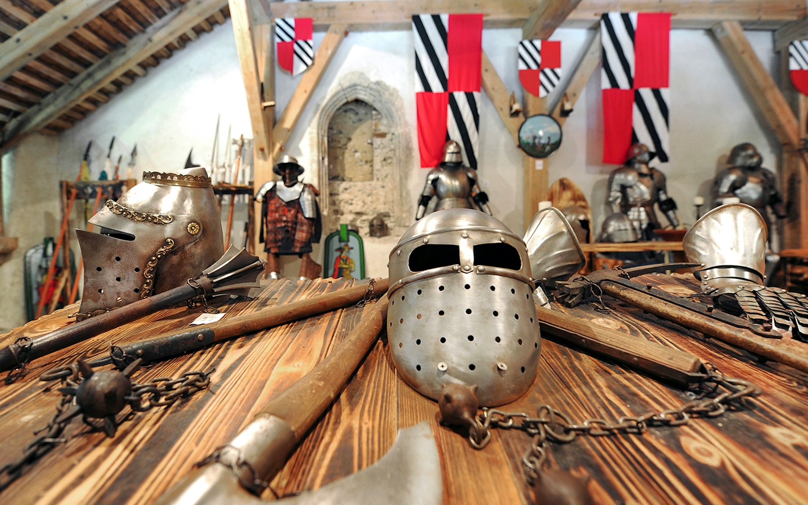 Medieval armor and weapons displayed inside Predjama Castle.