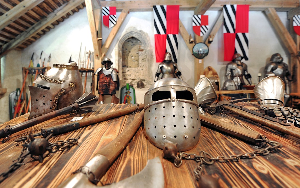 Medieval armor and weapons displayed inside Predjama Castle.