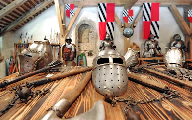 Medieval armor and weapons displayed inside Predjama Castle.