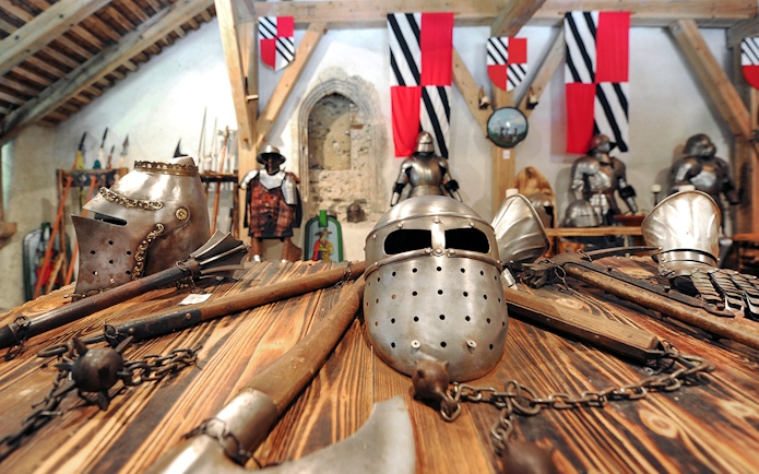Medieval armor and weapons displayed inside Predjama Castle.