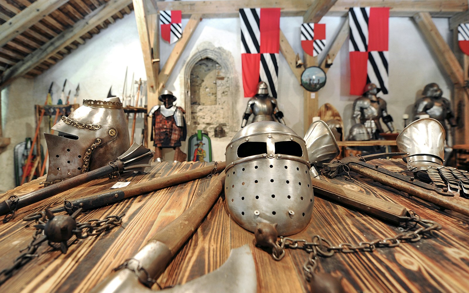 Medieval armor and weapons displayed inside Predjama Castle.