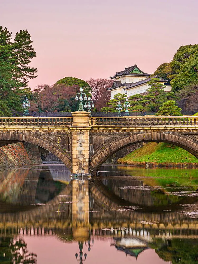 Imperial Palace bridge over moat at sunset, Tokyo, Japan.