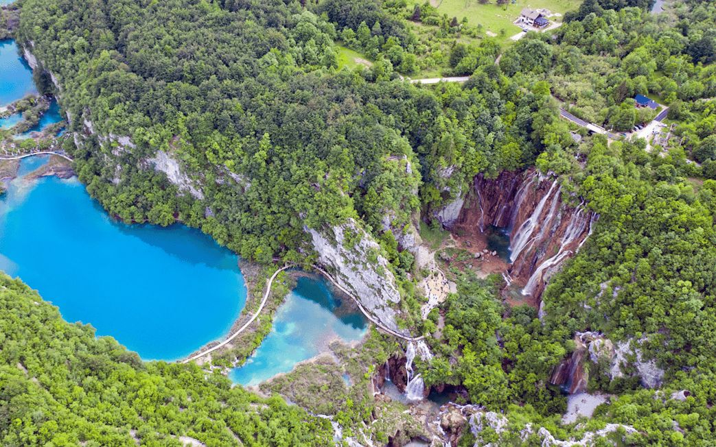 Aerial view of Plitvice Lakes with waterfalls and lush greenery in Croatia.