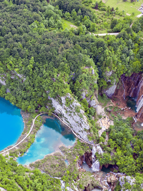 Aerial view of Plitvice Lakes with waterfalls and lush greenery in Croatia.