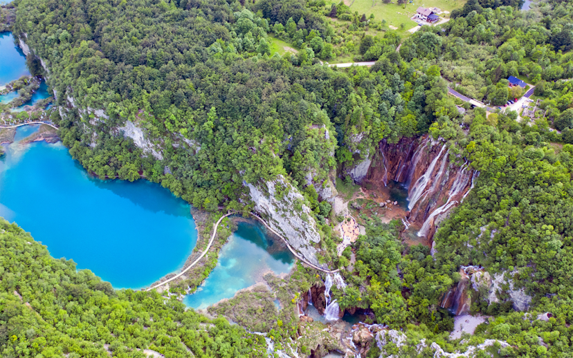 Aerial view of Plitvice Lakes with waterfalls and lush greenery in Croatia.