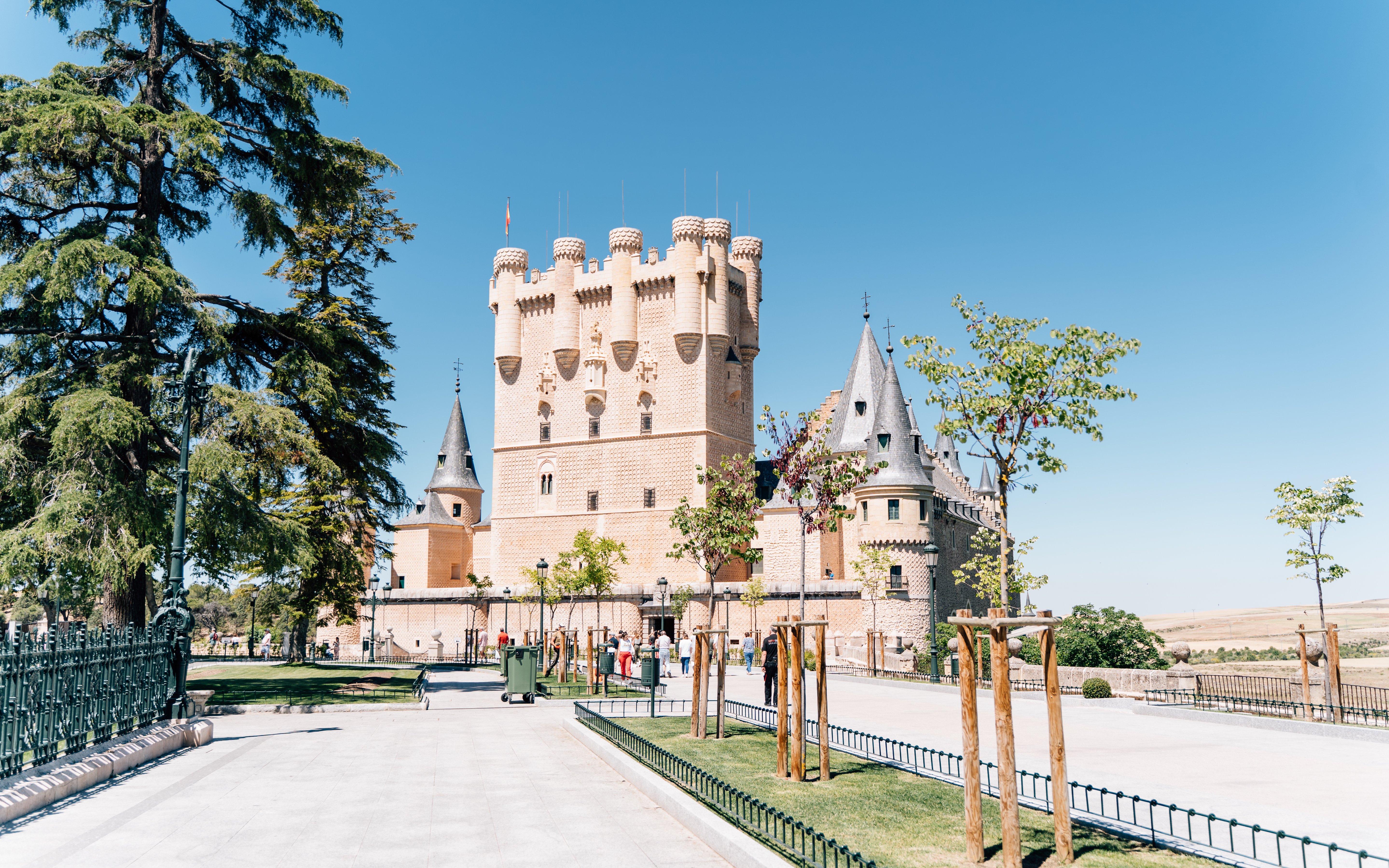 Alcázar of Segovia, a historic castle in Segovia, Spain, with towers and surrounding trees.