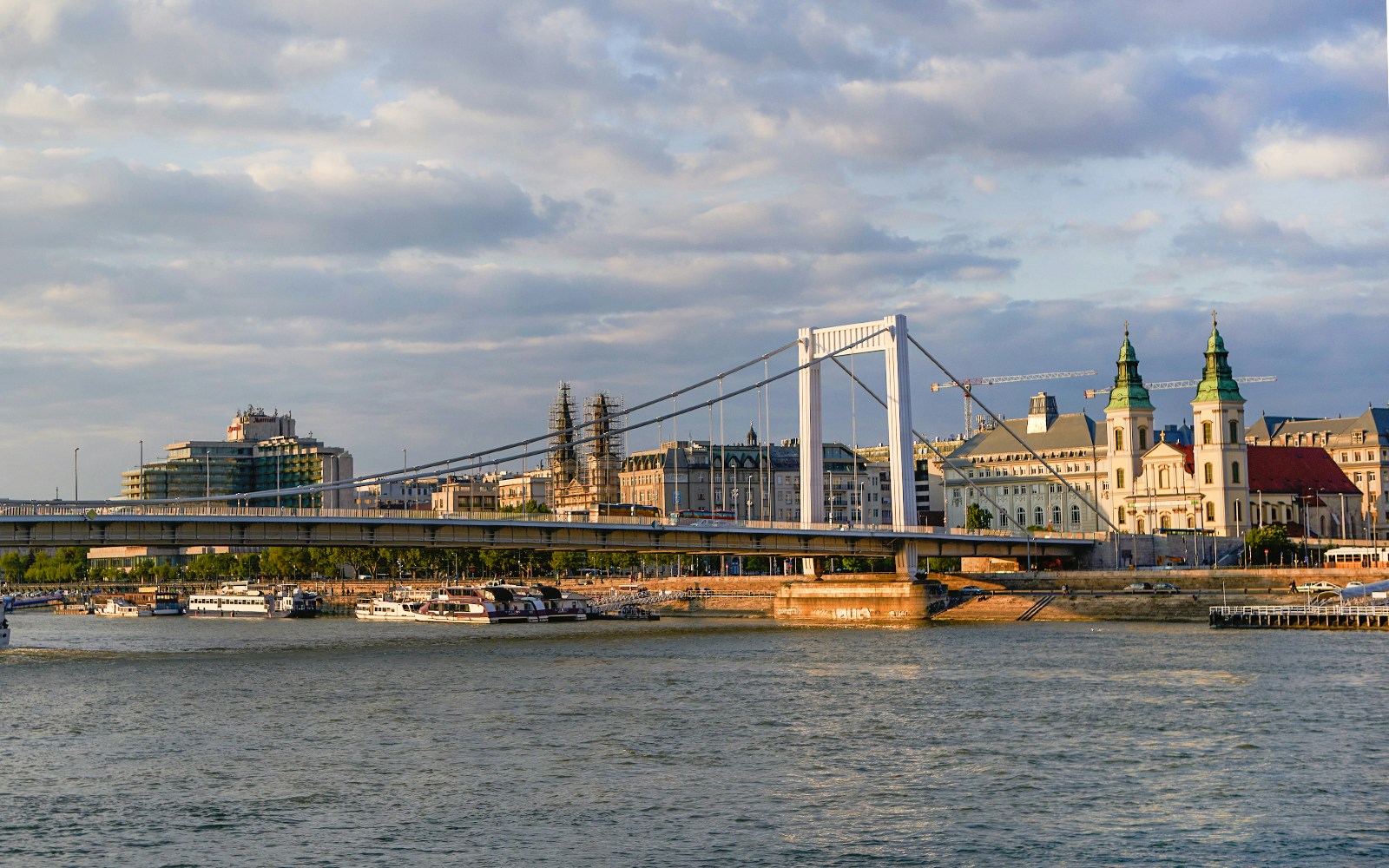 Elisabeth Bridge spanning the Danube River in Budapest with cityscape in the background.