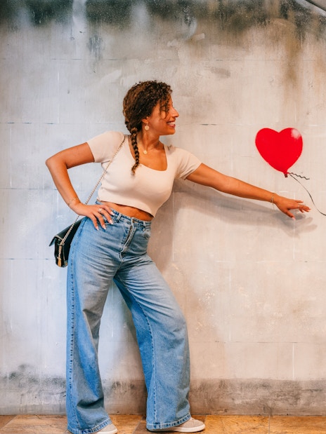 Tourist interacting with Banksy artwork at Banksy Museum Barcelona.