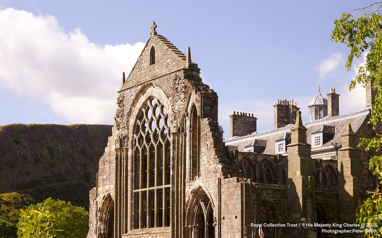 Holyrood Abbey ruins at the Palace of Holyroodhouse, Edinburgh, with Arthur's Seat in the background.