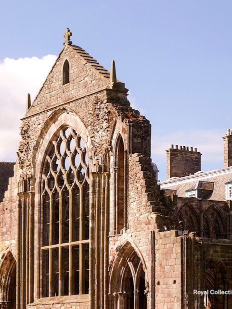 Holyrood Abbey ruins at the Palace of Holyroodhouse, Edinburgh, with Arthur's Seat in the background.