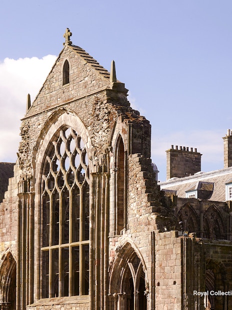 Holyrood Abbey ruins at the Palace of Holyroodhouse, Edinburgh, with Arthur's Seat in the background.