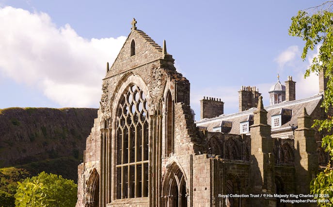 Holyrood Abbey ruins at the Palace of Holyroodhouse, Edinburgh, with Arthur's Seat in the background.