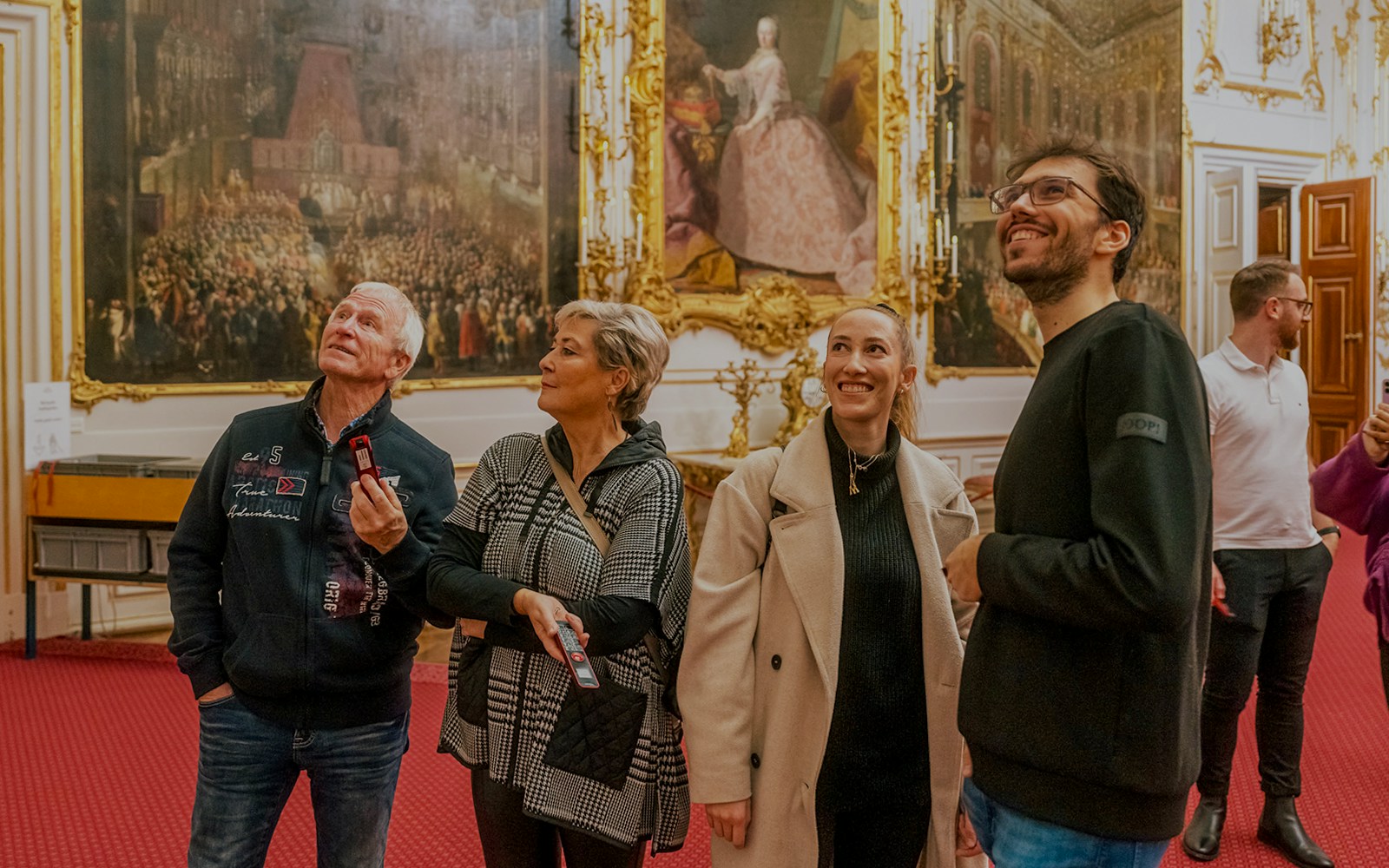 Visitors admiring artwork inside Schonbrunn Palace, Vienna.