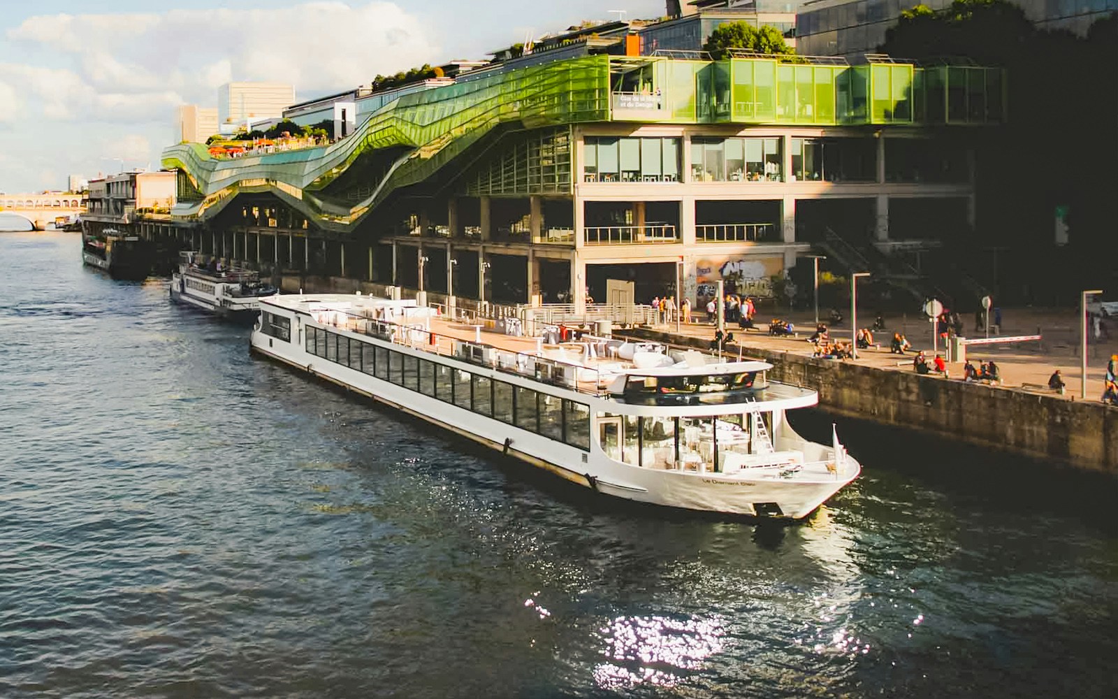 Seine River dinner cruise on Le Diamant Bleu with live music, Paris landmarks in view.