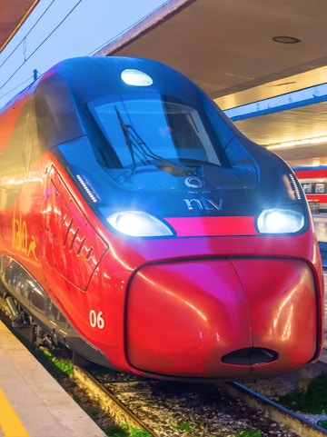Frecciarossa high-speed train at a station platform in Italy.