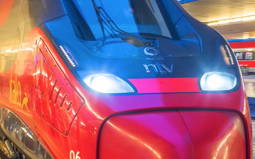 Frecciarossa high-speed train at a station platform in Italy.