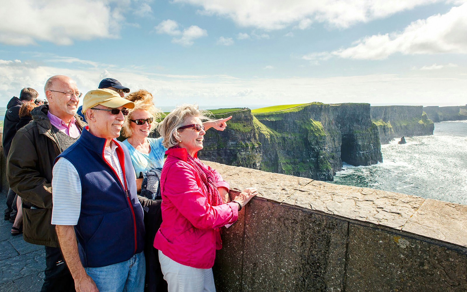 Tourists enjoying the view at Cliffs of Moher, Ireland.