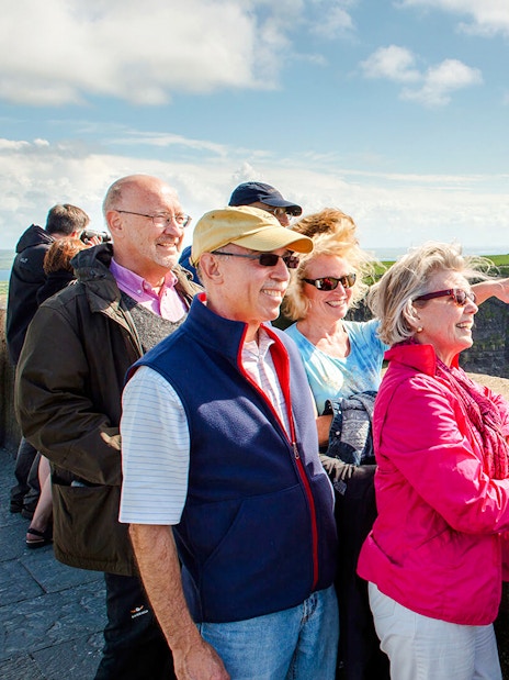 Tourists enjoying the view at Cliffs of Moher, Ireland.