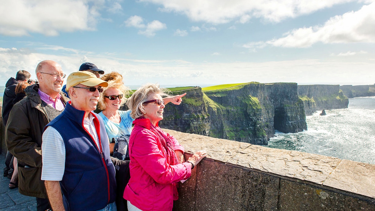 Tourists enjoying the view at Cliffs of Moher, Ireland.