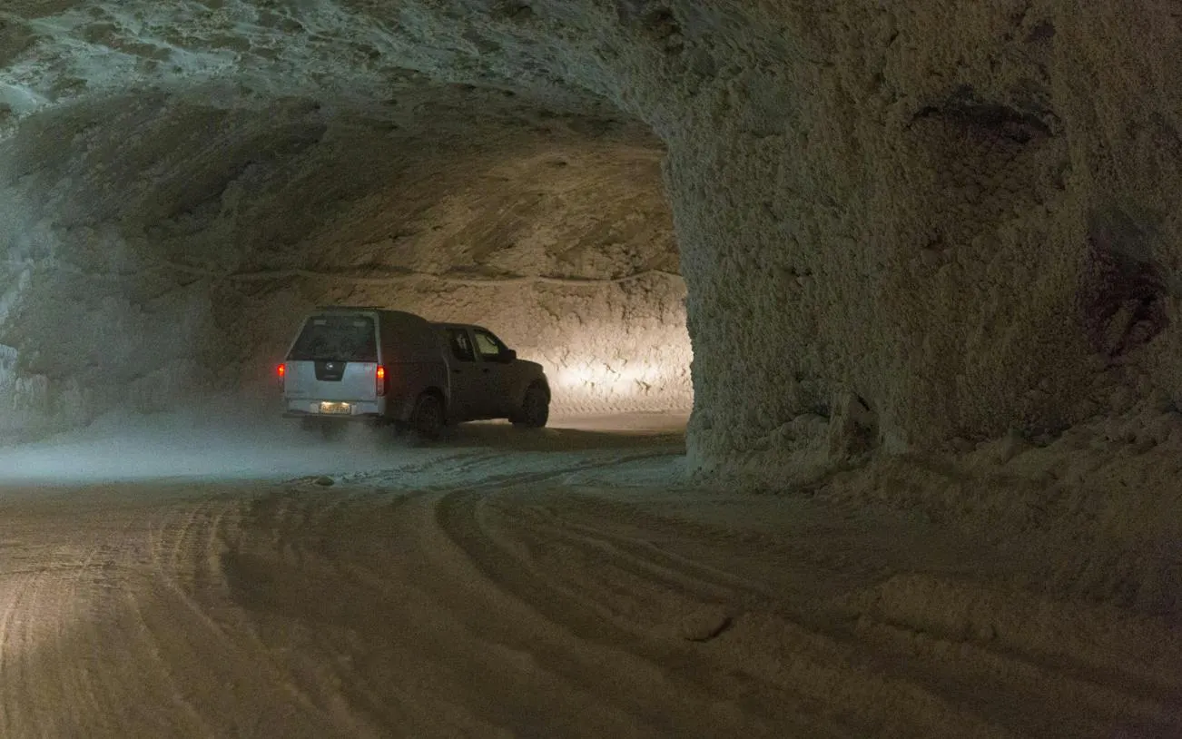Vehicle driving through Slanic Prahova Salt Mine tunnel on Bucharest day trip.