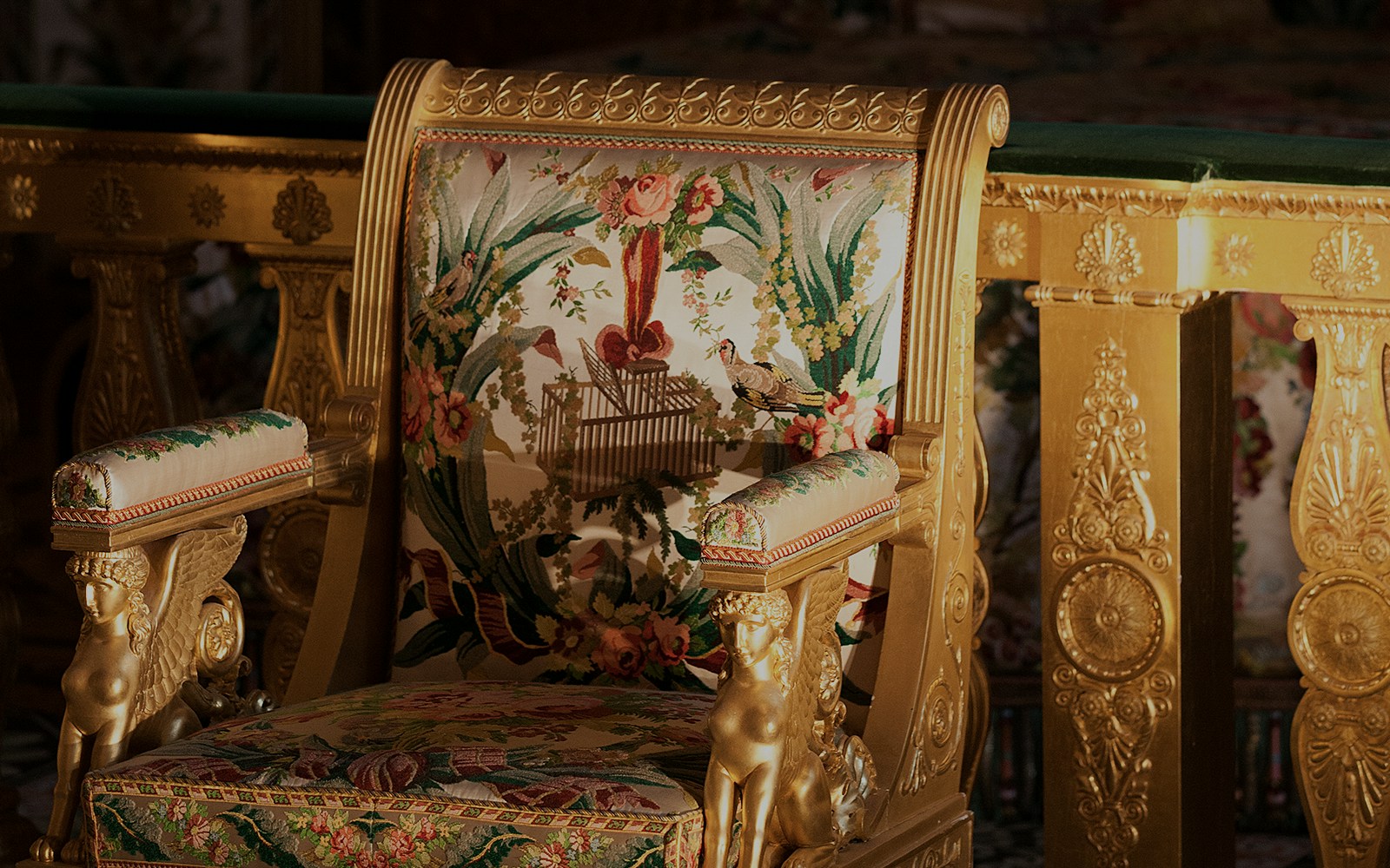 Chateau de Fontainebleau Chinese Salon ornate chair with floral tapestry and gold detailing.