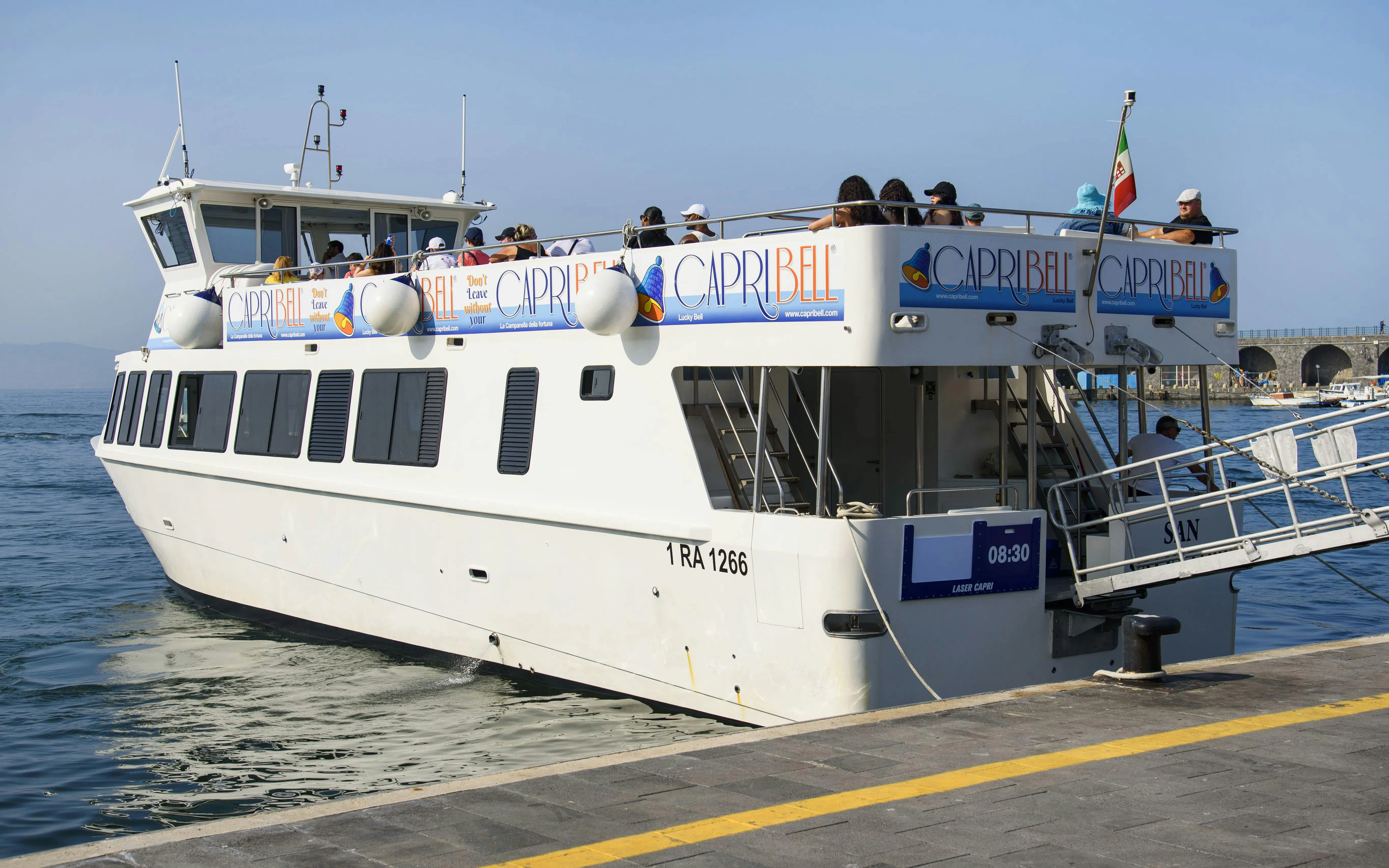 Cruise passengers disembarking at Amalfi Coast pier.