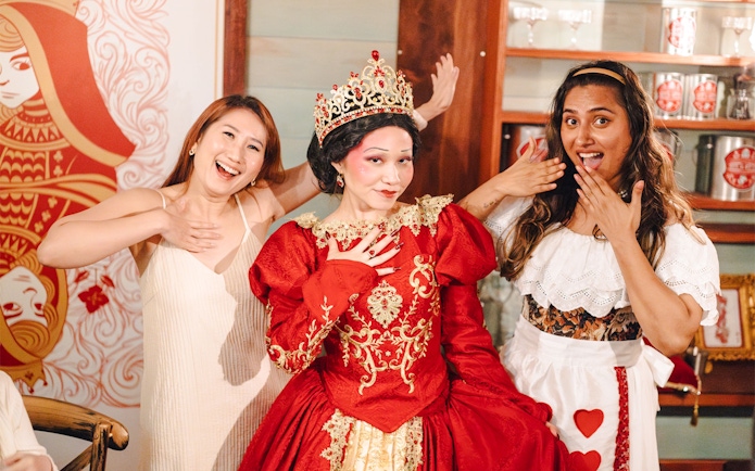Guests with Queen of Hearts at Wonderland Upside Down experience.