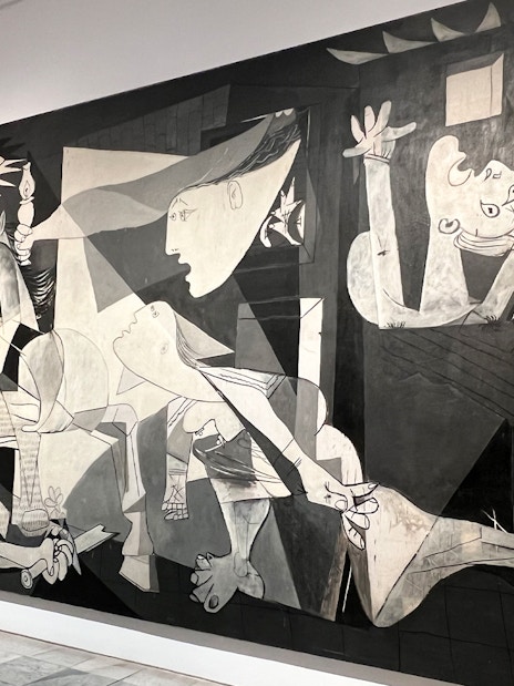 Tour guide explaining Picasso's Guernica at Prado & Reina Sofia Museum in Madrid.